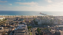 Sun-drenched rooftops and swaying palms lead to the iconic pier stretching into the Pacific.