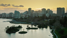 Oakland's skyline glows warm as golden light spills across the shimmering estuary at dusk.