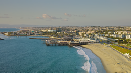 Waves roll gently onto the sun-drenched shores of this Southern California coastal town.