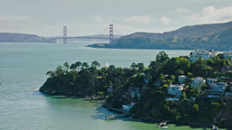 Tiburon's wooded peninsula reaches into the bay with the Golden Gate standing watch beyond.