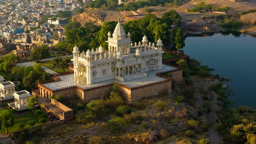 Jaswant Thada's white marble cenotaph gleams beside a tranquil lake in the golden light of Jodhpur.