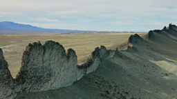 Ancient volcanic spires rise dramatically from the vast desert floor of northwestern New Mexico.