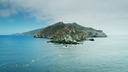 Rugged cliffs rise from the deep blue Pacific waters surrounding Santa Catalina Island.